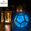 Infinity Ziantful Magic Table Lamp illuminating in blue next to a traditional lantern, showcasing modern and classic lighting styles.