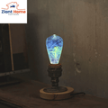 Super Old Skool Retro Light Base by Ziant Home, glowing blue and green bulb on a vintage wood desk, perfect for loft style elegant homes.