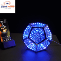 Infinity Ziantful Magic Table Lamp with 7 color options, remote control, and over 300 multi-color effects glowing blue on a table.